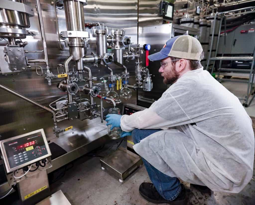 worker using wiped film distillation machine