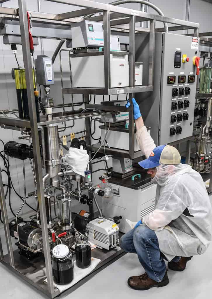 Man in PPE operating extraction equipment