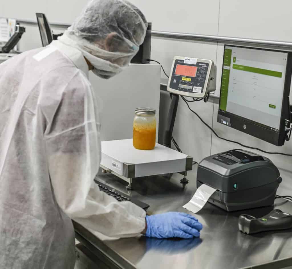 Personnel weighing distillate with igwLAB