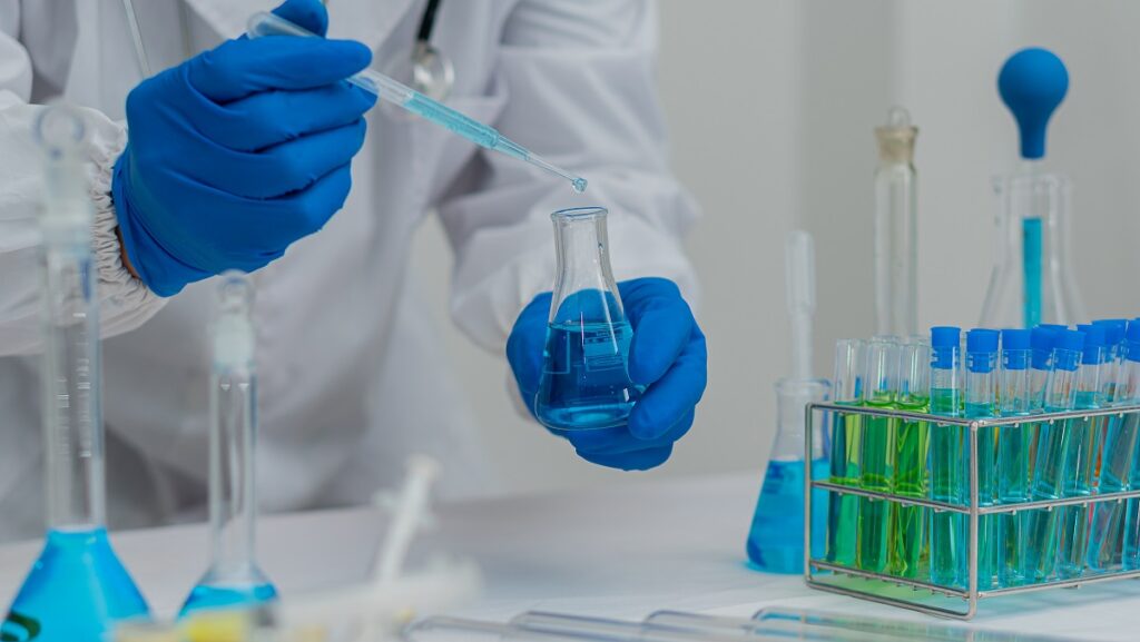 laboratory scientists work with in vitro liquid test tubes for h