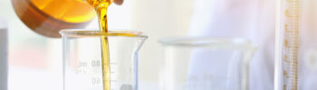 scientist oil pouring glass